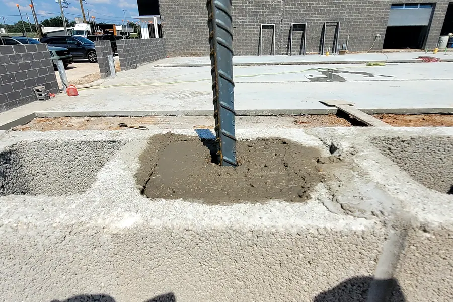 Steel rebar set into fresh concrete on a North Texas concrete project