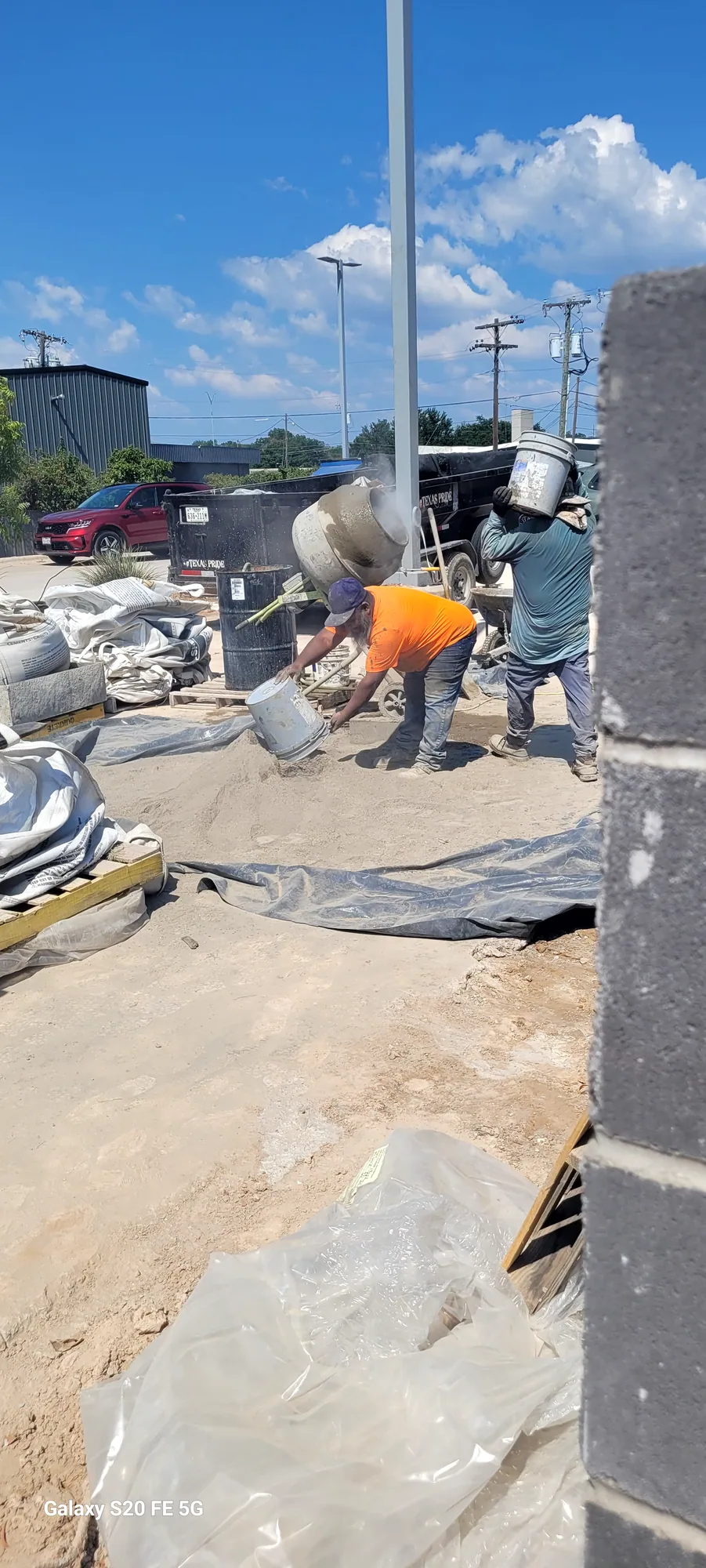 Concrete crew placing and finishing concrete on a sunny North Texas job site
