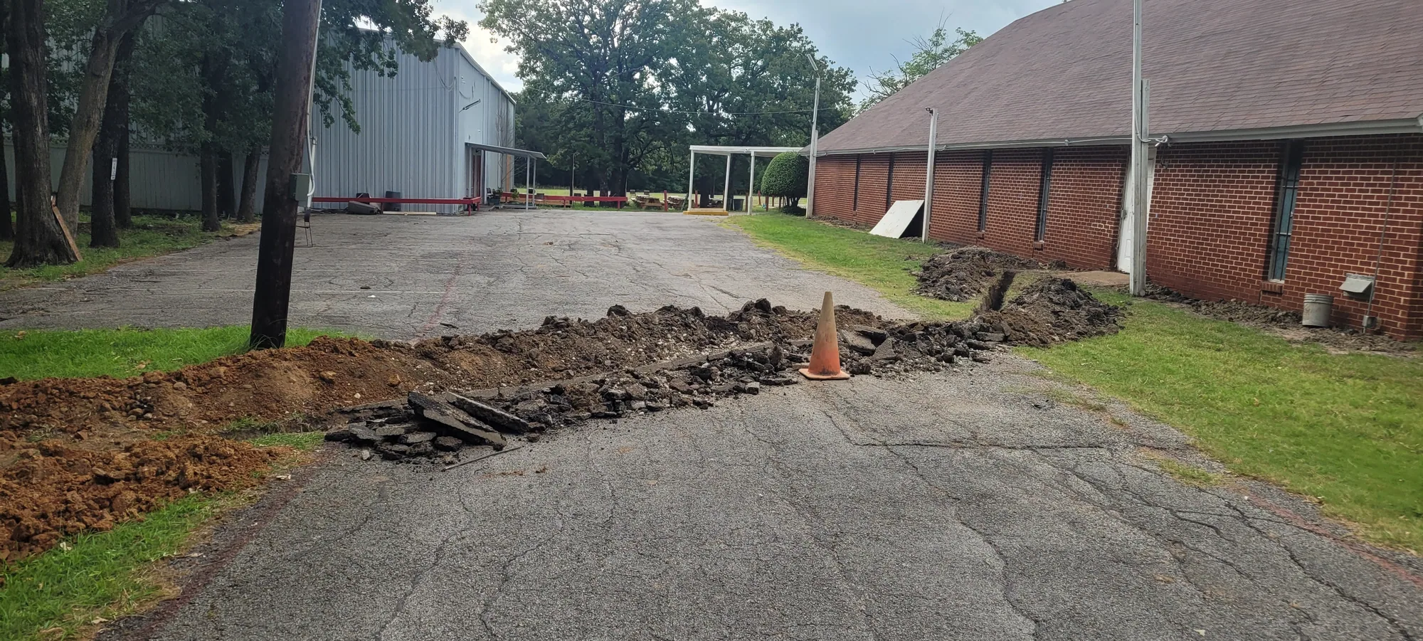 Excavated drainage trench across a residential yard in a growing North Texas suburb