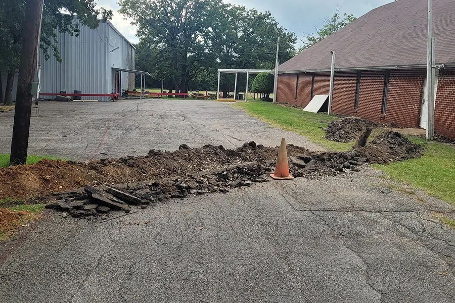 Excavated drainage trench across a residential yard in a growing North Texas suburb
