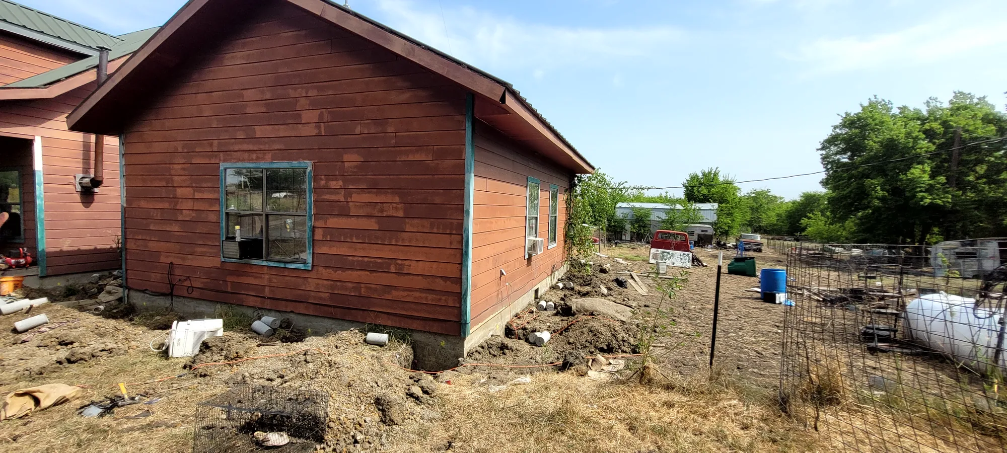 Painted wood siding and trim on the exterior of a North Texas home during repair work