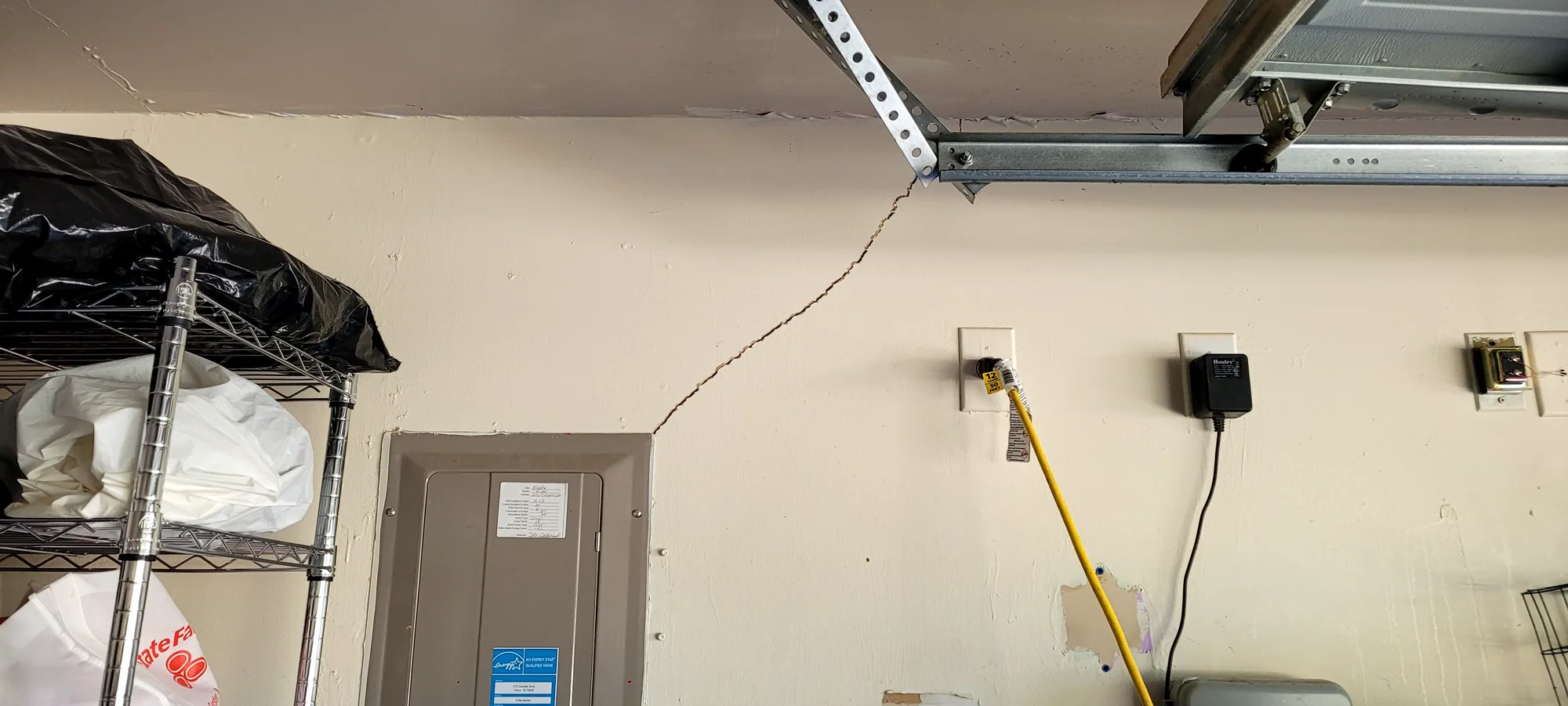 Diagonal drywall crack running from the corner of an interior door frame