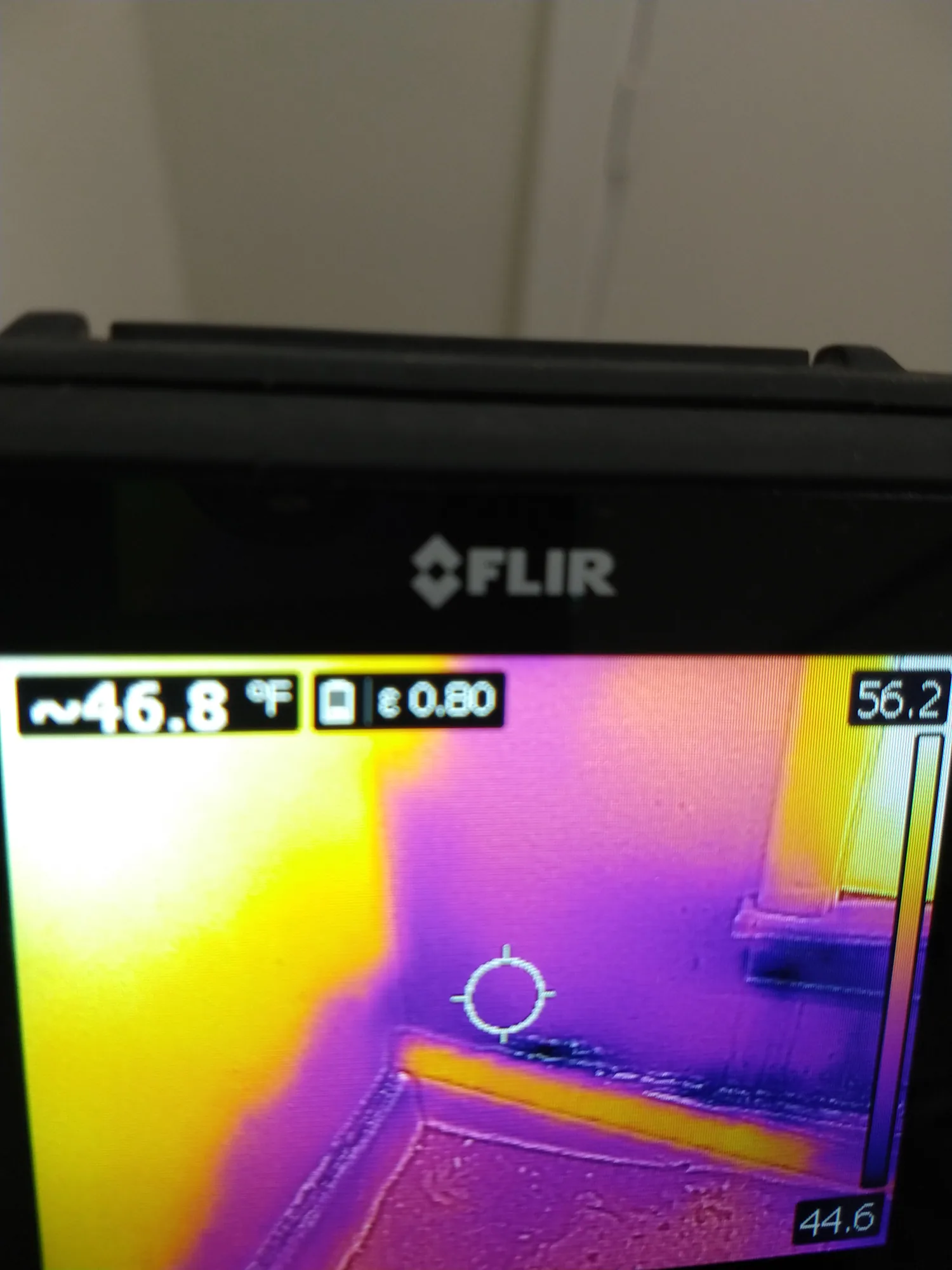 Thermal imaging camera screen showing a warm spot from a hidden water leak