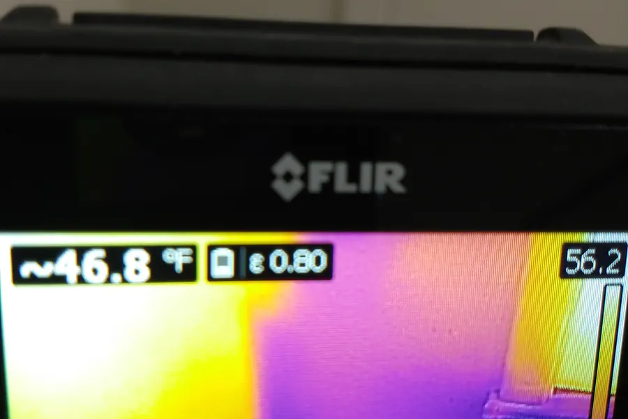 Thermal imaging camera screen showing a warm spot from a hidden water leak